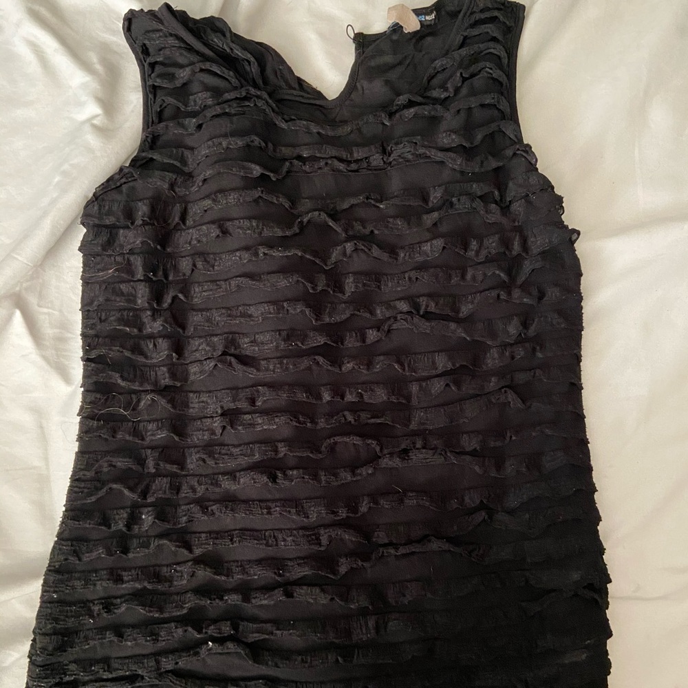 Ruffle sleeveless blouse.
